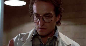 Movie still from “Night of the Creeps” (1986), directed by Fred Dekker – A person wearing glasses and a jacket; Close Up shot, Low angle