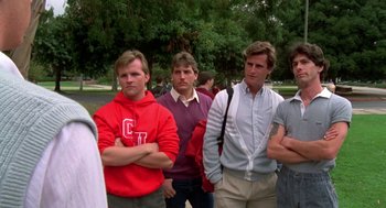 Movie still from “Night of the Creeps” (1986), directed by Fred Dekker – A group of young men standing next to each other; Medium shot, Low angle