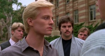 Movie still from “Night of the Creeps” (1986), directed by Fred Dekker – Two men standing next to each other in front of a brick building; Close Up shot, Low angle