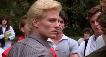 Movie still from “Night of the Creeps” (1986), directed by Fred Dekker – A man with blonde hair wearing a red tie; Close Up shot, Low angle