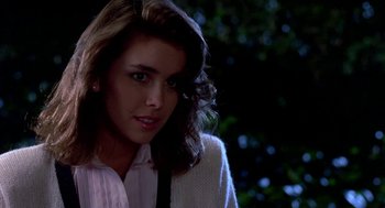Movie still from “Night of the Creeps” (1986), directed by Fred Dekker – A young woman in a white shirt and a black tie; Close Up shot, Over the shoulder angle