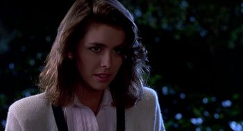 Movie still from “Night of the Creeps” (1986), directed by Fred Dekker – A woman with long dark hair wearing a pink shirt; Close Up shot, Over the shoulder angle