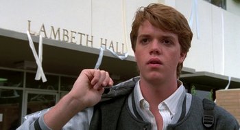 Movie still from “Night of the Creeps” (1986), directed by Fred Dekker – A young man holding his jacket over his shoulder; Close Up shot, Low angle