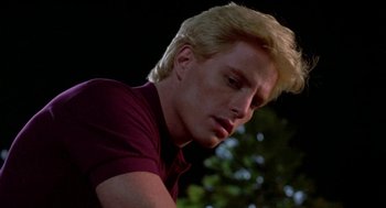Movie still from “Night of the Creeps” (1986), directed by Fred Dekker – A man with blonde hair is looking down; Close Up shot, Low angle
