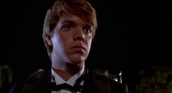 Movie still from “Night of the Creeps” (1986), directed by Fred Dekker – A man in a suit and bow tie looking to his left; Close Up shot, Low angle