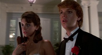 Movie still from “Night of the Creeps” (1986), directed by Fred Dekker – A man and a woman standing next to each other in formal wear; Close Up shot, Low angle