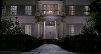 Movie still from “Night of the Creeps” (1986), directed by Fred Dekker – A large white building with the letters " kae " written on it; Extreme Wide shot, Low angle