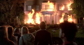 Movie still from “Night of the Creeps” (1986), directed by Fred Dekker – People watching a house on fire at night; Wide shot, Low angle