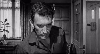 Movie still from “Night of the Eagle” (1962), directed by Sidney Hayers – Black and white photograph of a man looking down; Close Up shot, High angle