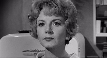 Movie still from “Night of the Eagle” (1962), directed by Sidney Hayers – An old black and white photo of a woman with short hair; Close Up shot, Low angle