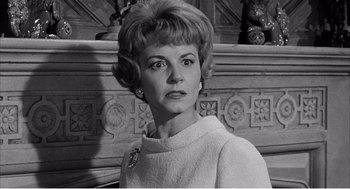 Movie still from “Night of the Eagle” (1962), directed by Sidney Hayers – An old black and white photo of a woman; Close Up shot, Low angle