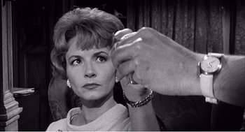 Movie still from “Night of the Eagle” (1962), directed by Sidney Hayers – An older woman getting her hair done in a salon; Close Up shot, Low angle