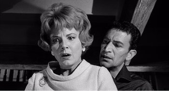 Movie still from “Night of the Eagle” (1962), directed by Sidney Hayers – An old photo of a woman and a man; Close Up shot, Low angle