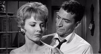 Movie still from “Night of the Eagle” (1962), directed by Sidney Hayers – An older man and a younger woman in a black and white photo; Close Up shot, Over the shoulder angle