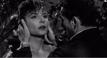 Movie still from “Night of the Eagle” (1962), directed by Sidney Hayers – A man touching the face of a beautiful woman; Close Up shot, Over the shoulder angle