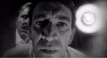 Movie still from “Night of the Eagle” (1962), directed by Sidney Hayers – A black and white photo of a man's face; Close Up shot, Low angle
