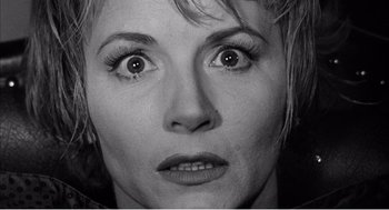 Movie still from “Night of the Eagle” (1962), directed by Sidney Hayers – A person's face with eyes wide open; Close Up shot, High angle