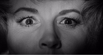 Movie still from “Night of the Eagle” (1962), directed by Sidney Hayers – A woman's eyes with long lashes; Extreme Close Up shot, Overhead angle