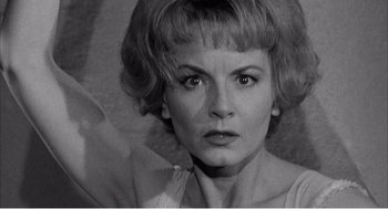 Movie still from “Night of the Eagle” (1962), directed by Sidney Hayers – An old photo of a woman with short blonde hair; Close Up shot, High angle