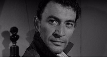 Movie still from “Night of the Eagle” (1962), directed by Sidney Hayers – Black and white photograph of a man in a jacket; Close Up shot, High angle