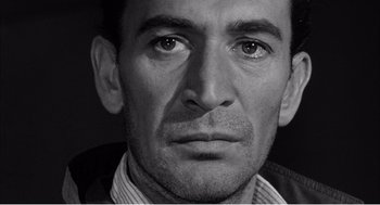 Movie still from “Night of the Eagle” (1962), directed by Sidney Hayers – Black and white close up of a man's face; Close Up shot, Low angle