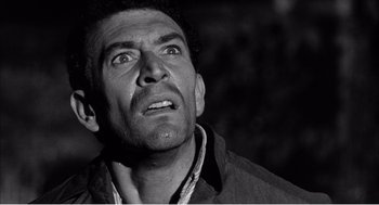 Movie still from “Night of the Eagle” (1962), directed by Sidney Hayers – Black and white photograph of a man crying; Close Up shot, Low angle