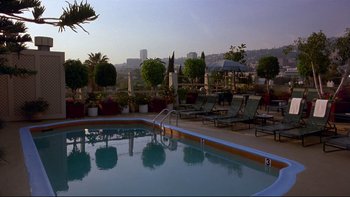 Movie still from “Night on Earth” (1991), directed by Jim Jarmusch – A swimming pool with a view of a city; Extreme Wide shot, High angle