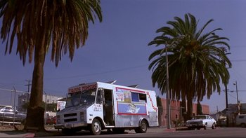 Movie still from “Night on Earth” (1991), directed by Jim Jarmusch – A food truck parked on the side of the street; Extreme Wide shot, Low angle