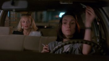 Movie still from “Night on Earth” (1991), directed by Jim Jarmusch – Two women sitting in the back seat of a car at night; Close Up shot, Over the shoulder angle