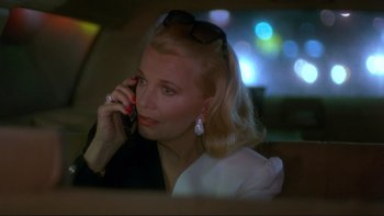 Movie still from “Night on Earth” (1991), directed by Jim Jarmusch – A woman talking on a cell phone while sitting in a car; Close Up shot, High angle