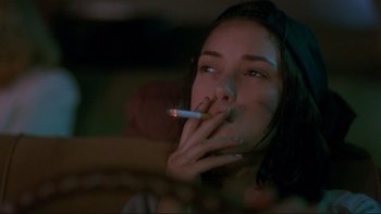 Movie still from “Night on Earth” (1991), directed by Jim Jarmusch – A woman is smoking a cigarette in the dark; Close Up shot, Over the shoulder angle