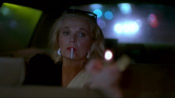 Movie still from “Night on Earth” (1991), directed by Jim Jarmusch – A woman smoking a cigarette in the backseat of a car; Close Up shot, Low angle