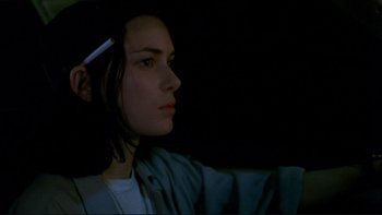 Movie still from “Night on Earth” (1991), directed by Jim Jarmusch – A woman is holding a cigarette in her hand; Close Up shot, Over the shoulder angle