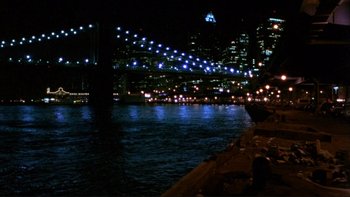 Movie still from “Night on Earth” (1991), directed by Jim Jarmusch – A view of a bridge lit up at night; Extreme Wide shot, High angle