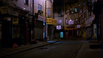 Movie still from “Night on Earth” (1991), directed by Jim Jarmusch – An empty street at night in an urban setting; Extreme Wide shot, High angle