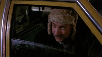 Movie still from “Night on Earth” (1991), directed by Jim Jarmusch – A man wearing a hat looking out of the window of a car; Close Up shot, Low angle