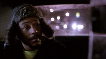 Movie still from “Night on Earth” (1991), directed by Jim Jarmusch – A man in a fur hat sitting in a car; Close Up shot, Low angle