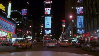 Movie still from “Night on Earth” (1991), directed by Jim Jarmusch – Cars driving down a city street at night time; Extreme Wide shot, High angle