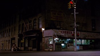 Movie still from “Night on Earth” (1991), directed by Jim Jarmusch – A street corner at night with a traffic light; Extreme Wide shot, High angle