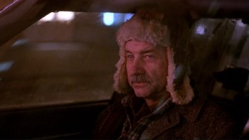 Movie still from “Night on Earth” (1991), directed by Jim Jarmusch – A man wearing a hat sitting in the back of a car; Close Up shot, Low angle