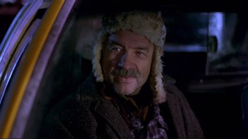 Movie still from “Night on Earth” (1991), directed by Jim Jarmusch – A man in a fur hat sitting in the back of a car; Close Up shot, Low angle