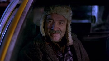 Movie still from “Night on Earth” (1991), directed by Jim Jarmusch – A man in a fur hat sitting in the back of a car; Close Up shot, Low angle