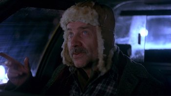 Movie still from “Night on Earth” (1991), directed by Jim Jarmusch – A person wearing a hat; Close Up shot, Over the shoulder angle