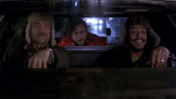 Movie still from “Night on Earth” (1991), directed by Jim Jarmusch – A group of people in a car looking out of the window; Medium shot, Over the shoulder angle