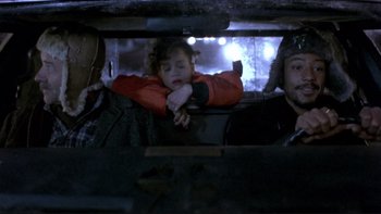Movie still from “Night on Earth” (1991), directed by Jim Jarmusch – A group of people sitting in a vehicle; Medium shot, High angle