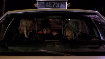 Movie still from “Night on Earth” (1991), directed by Jim Jarmusch – Two people in a taxi looking out of the window; Close Up shot, Over the shoulder angle