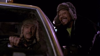Movie still from “Night on Earth” (1991), directed by Jim Jarmusch – Two men in the back seat of a car at night; Medium shot, Low angle