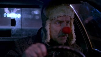 Movie still from “Night on Earth” (1991), directed by Jim Jarmusch – A man with a red clown nose driving a car; Close Up shot, Low angle