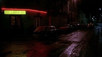 Movie still from “Night on Earth” (1991), directed by Jim Jarmusch – Cars parked on the side of the street at night; Extreme Wide shot, High angle