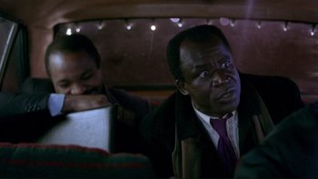 Movie still from “Night on Earth” (1991), directed by Jim Jarmusch – Two men sitting in the back seat of a car; Close Up shot, Over the shoulder angle